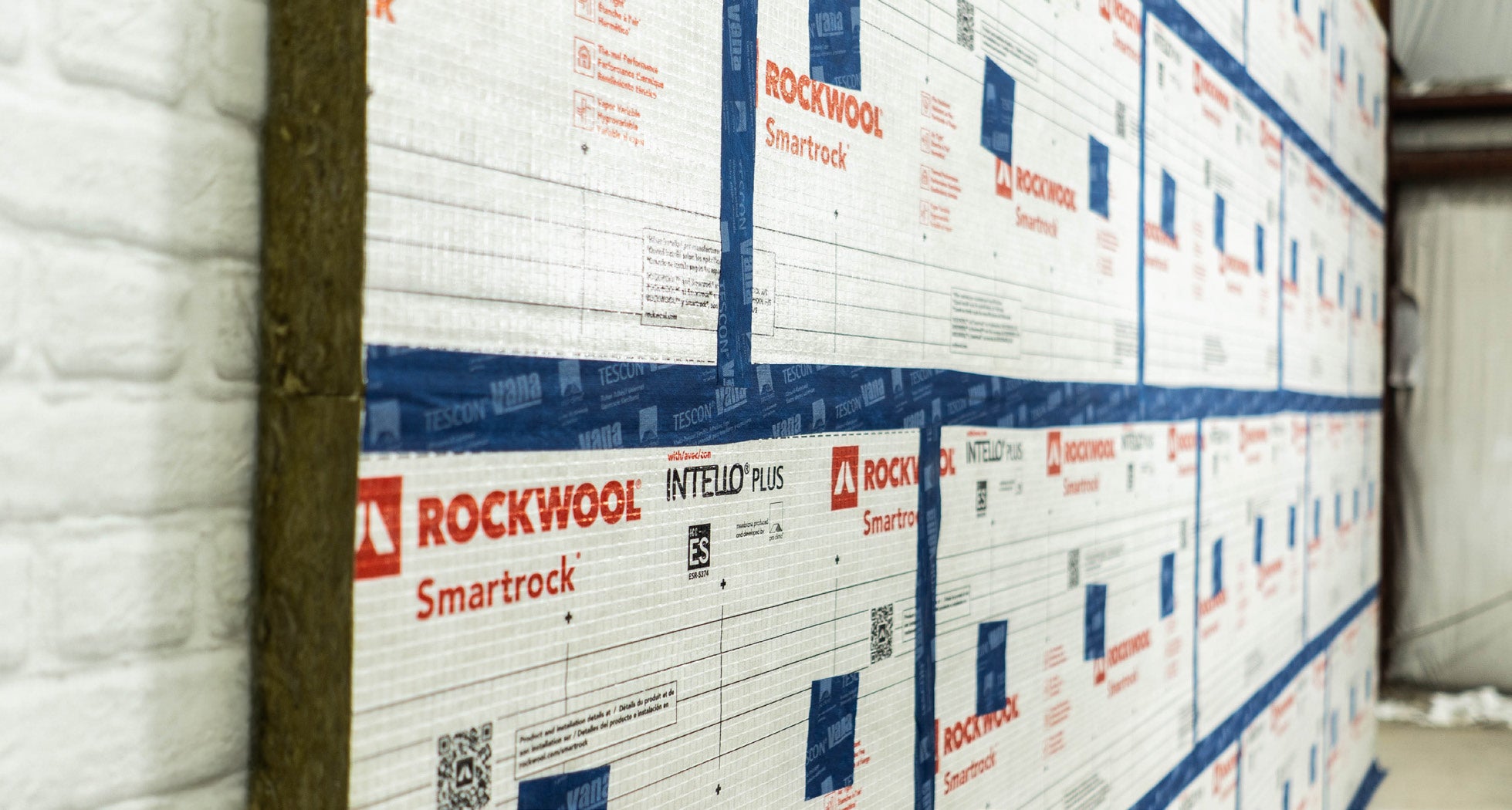 Smartrock continuous insulation installed and taped on a masonry wall
